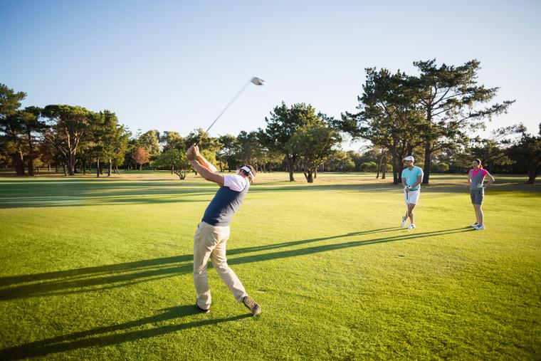 A group watching a tee shot