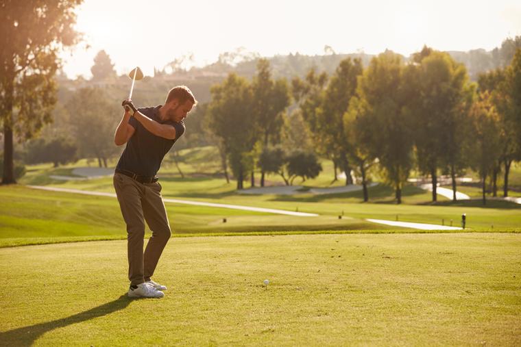 A golfer lining up a tee shot