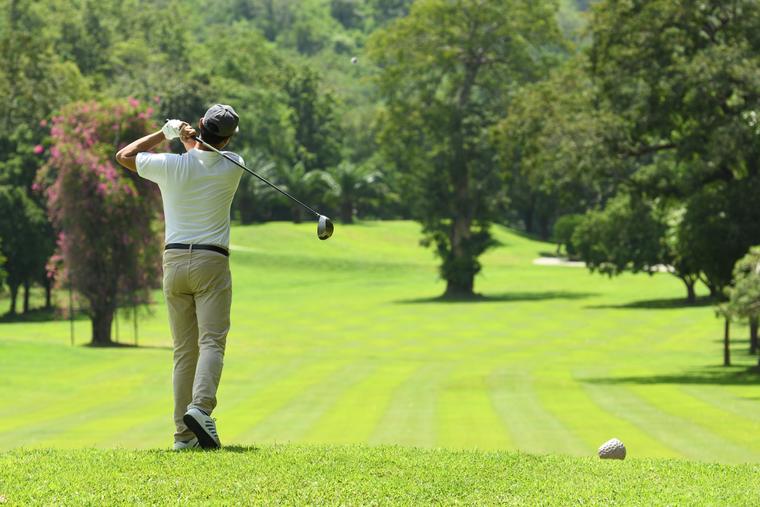 A golfer at the top of the backswing