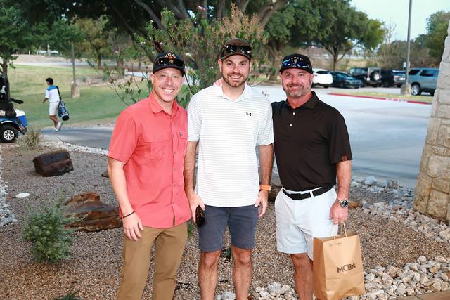 Three players posing outside the clubhouse as they arrive