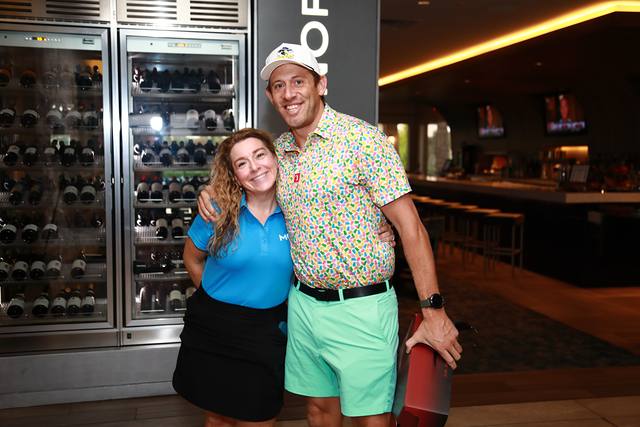 Two guests posing by the clubhouse bar