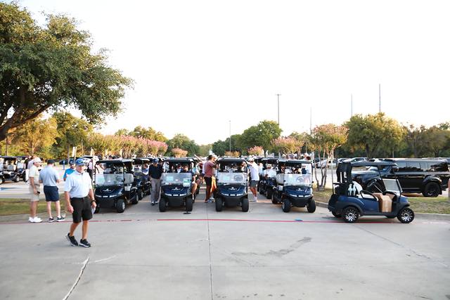 Players heading to their carts in the lot