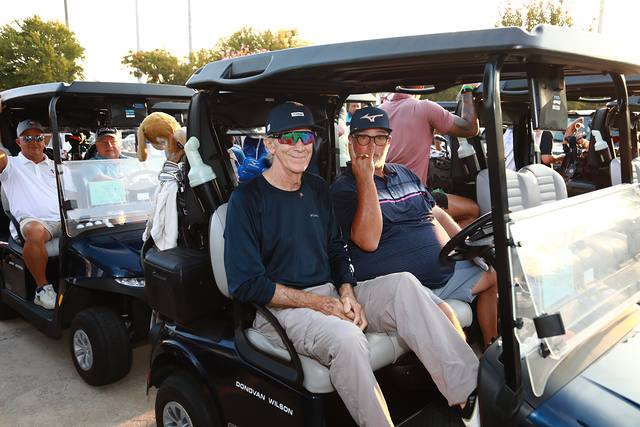 Two players settled into their cart before the shotgun start