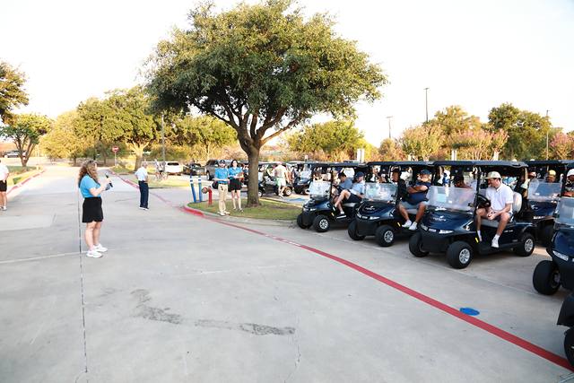 Players in their carts listening to announcements before the shotgun start