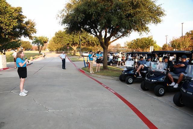 An MCBA team member making announcements to the carts