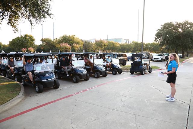 Players listening to announcements from their carts