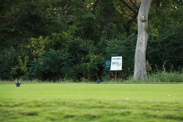 The Saville hole sponsor sign on a tree lined tee box