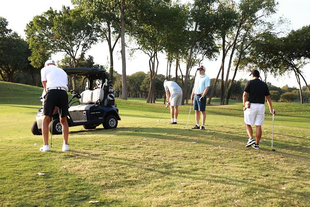 Players pulling clubs from their cart