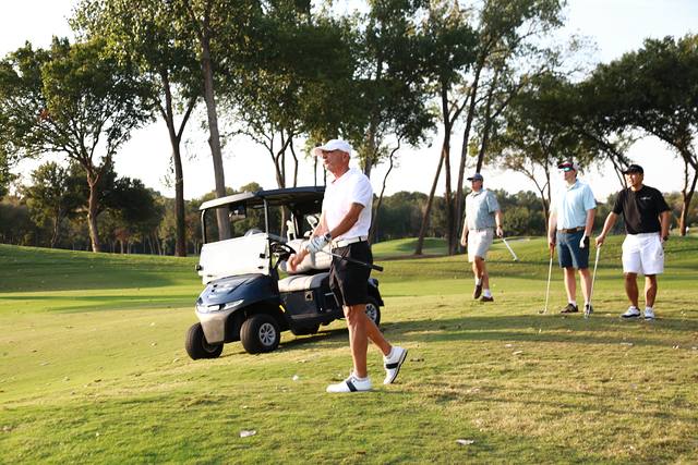 A group getting ready to hit beside their cart