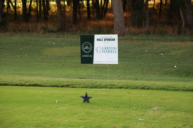 The Griffin Harris hole sponsor sign beside a Cowboys star tee marker
