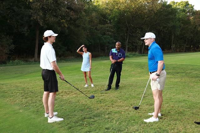 A group talking on a tee box before their first shot