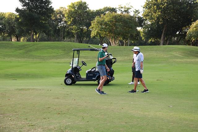 Two players walking from their cart on the fairway