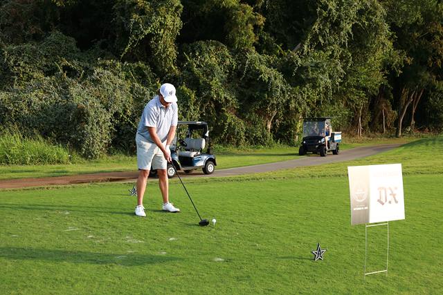 A player lining up beside The Dallas Express hole sponsor sign