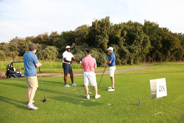 A group on the tee near The Dallas Express hole sponsor sign