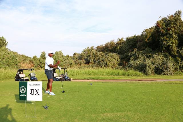 A player teeing off near The Dallas Express hole sponsor sign
