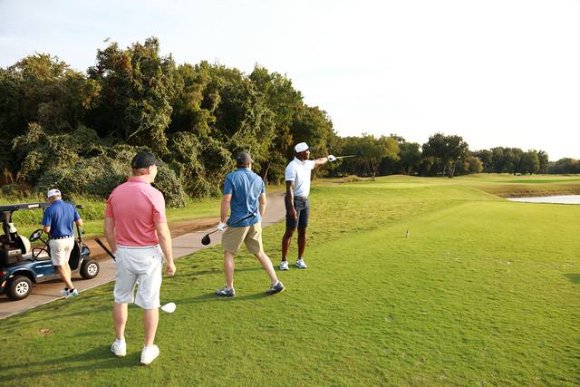 A group on the tee watching a drive