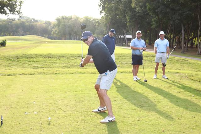 A player swinging while his group watches