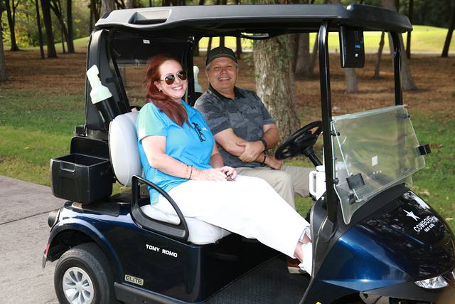 Two players smiling from their cart