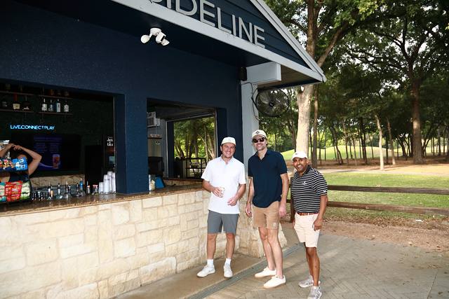 Three players posing at The Sideline snack stand