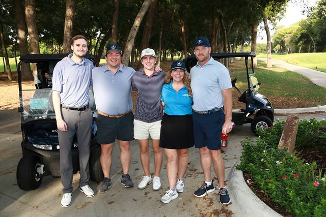 A group smiling in front of their carts