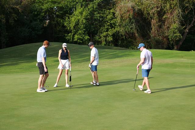 A group finishing up on a green