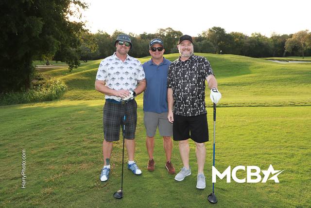 Three players smiling on the course