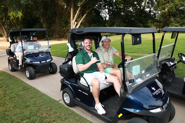Two players smiling from their cart