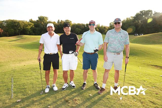 A group smiling on the course