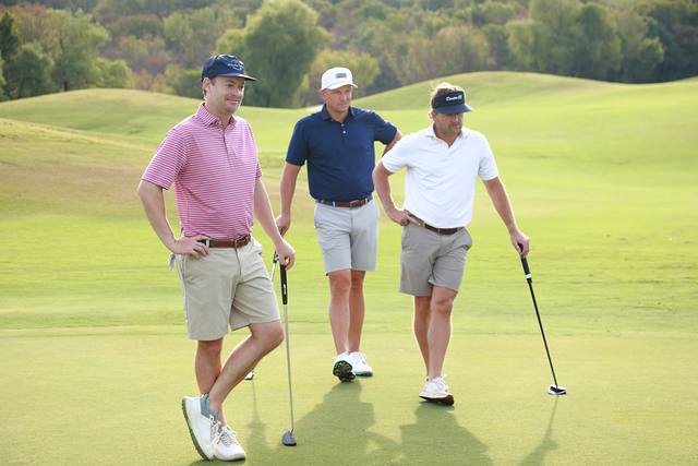 Three players standing on a green
