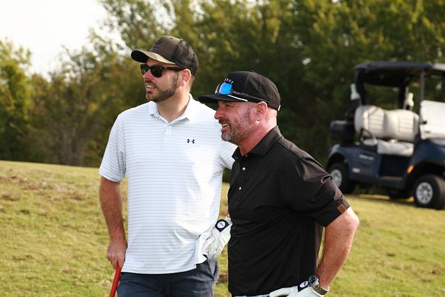 Two players talking beside their cart