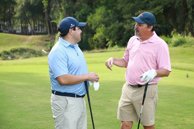 Two players talking on a tee box