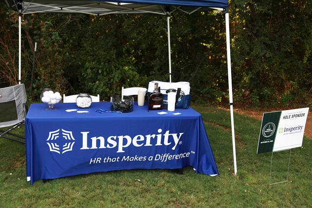 Insperity's table under its tent on the course