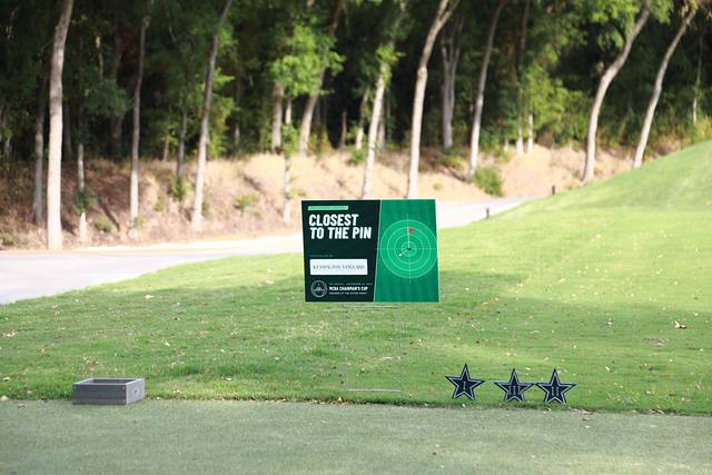 The Closest to the Pin sign on a tee box beside Cowboys star markers