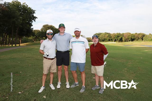 A group posing on a tee box