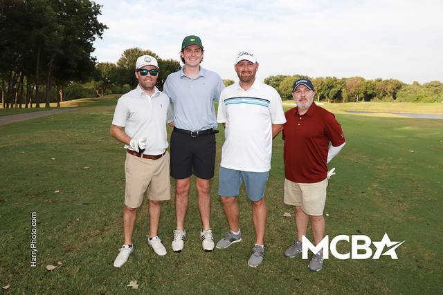 A group smiling on a tee box