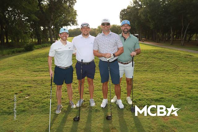 A group smiling on a fairway