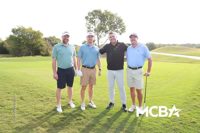 A group posing on the course