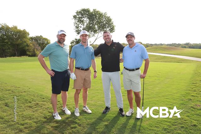 A group smiling on the course