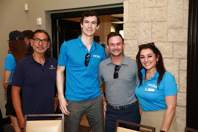 Four guests posing together in the clubhouse