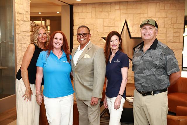 Five guests posing together in the clubhouse