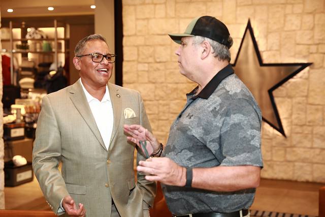 Two guests talking beside the Cowboys star