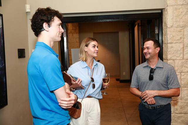 Three guests talking at the After Party