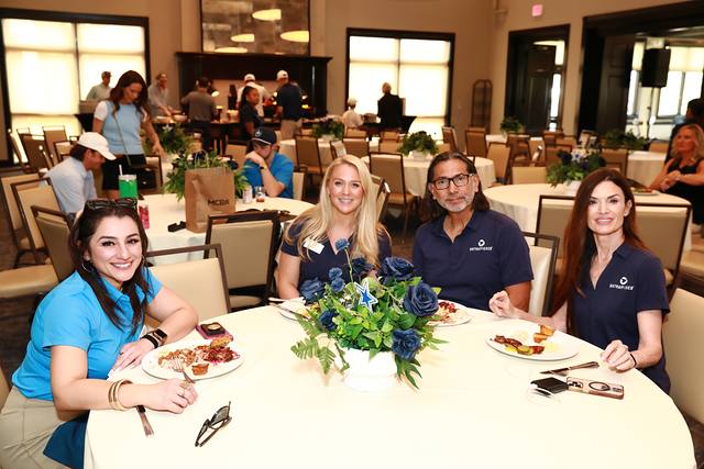 Guests eating lunch at a round table