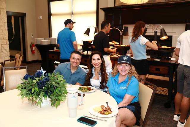Guests at a table with barbecue plates during the After Party lunch