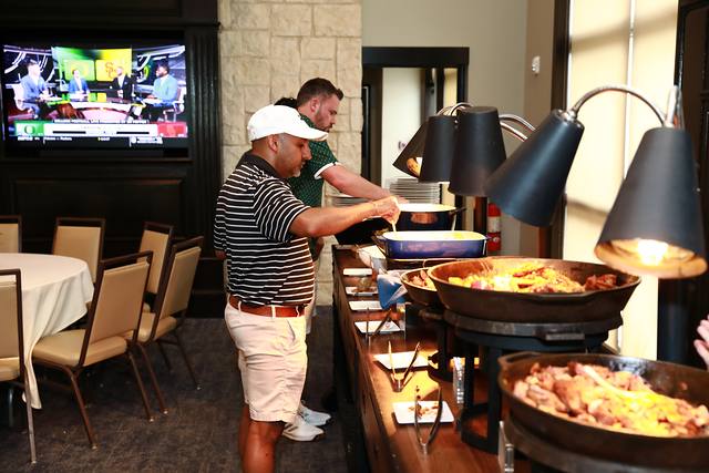 A guest serving himself at the barbecue buffet