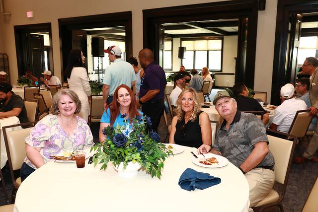 Guests smiling at a lunch table