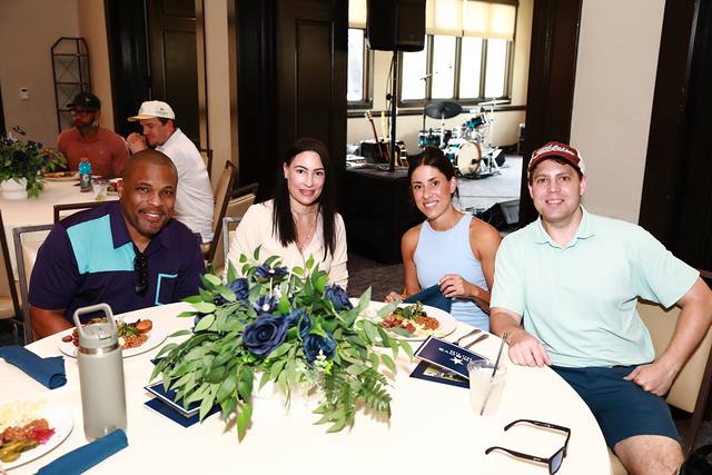Four guests at a lunch table