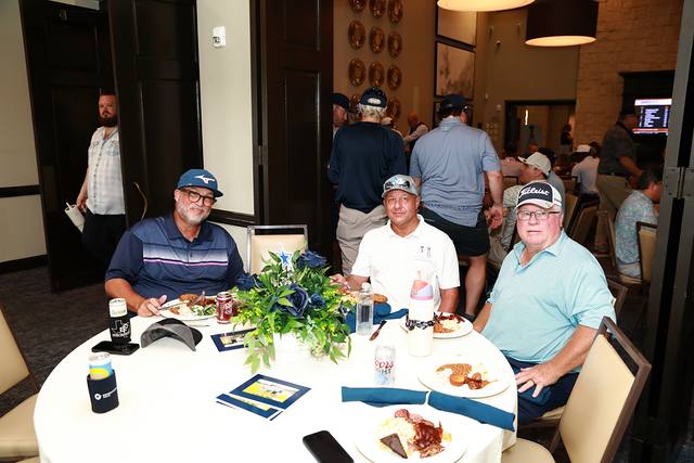 Three players at a lunch table