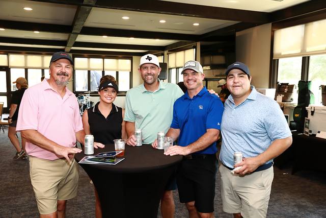 Five players gathered at a high top table