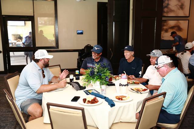 Players eating lunch at a round table